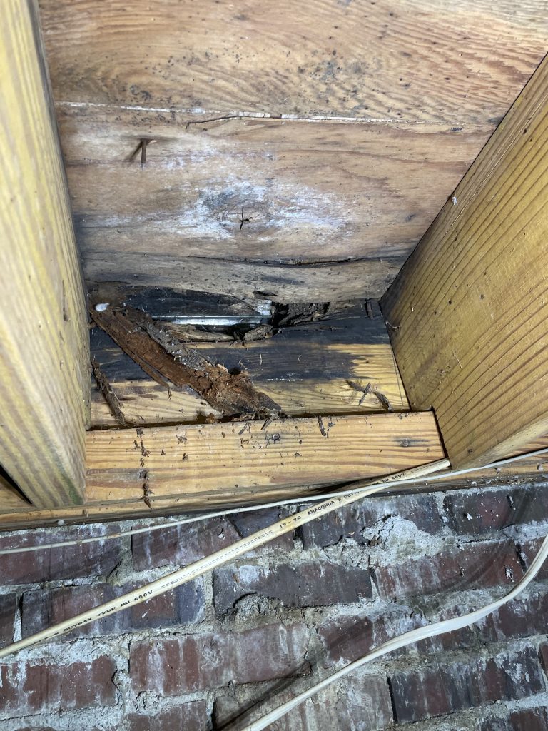 Wet rot on a band as seen from the crawlspace in the upstate of South Carolina