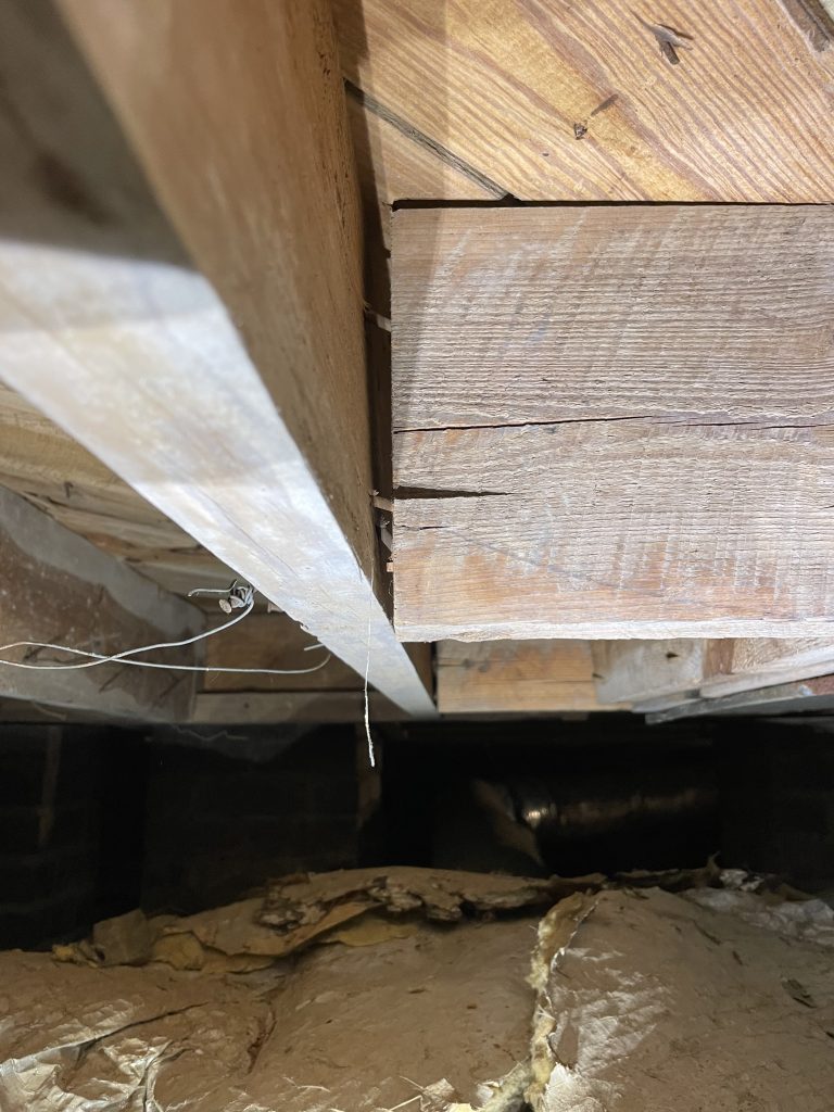 A floor joist pulling away after years of being only toe nailed in.
