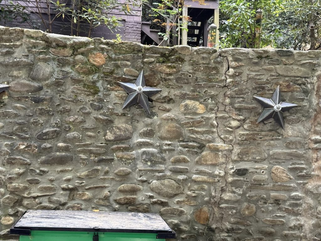 retaining wall repair with customer star plates on helical tie backs.